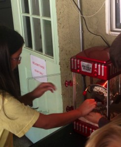 A Student Council member operating the new, student-run popcorn machine.